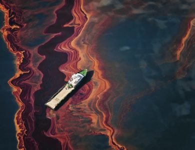 On May 6, 2010, a ship cuts through a band of oil on the surface of the Gulf of Mexico that seeped up from the Deepwater Horizon wellhead. Photo ? Daniel Beltra for Greenpeace.