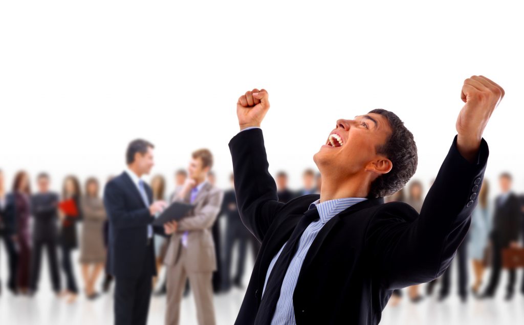 One very happy energetic businessman with his arms raised